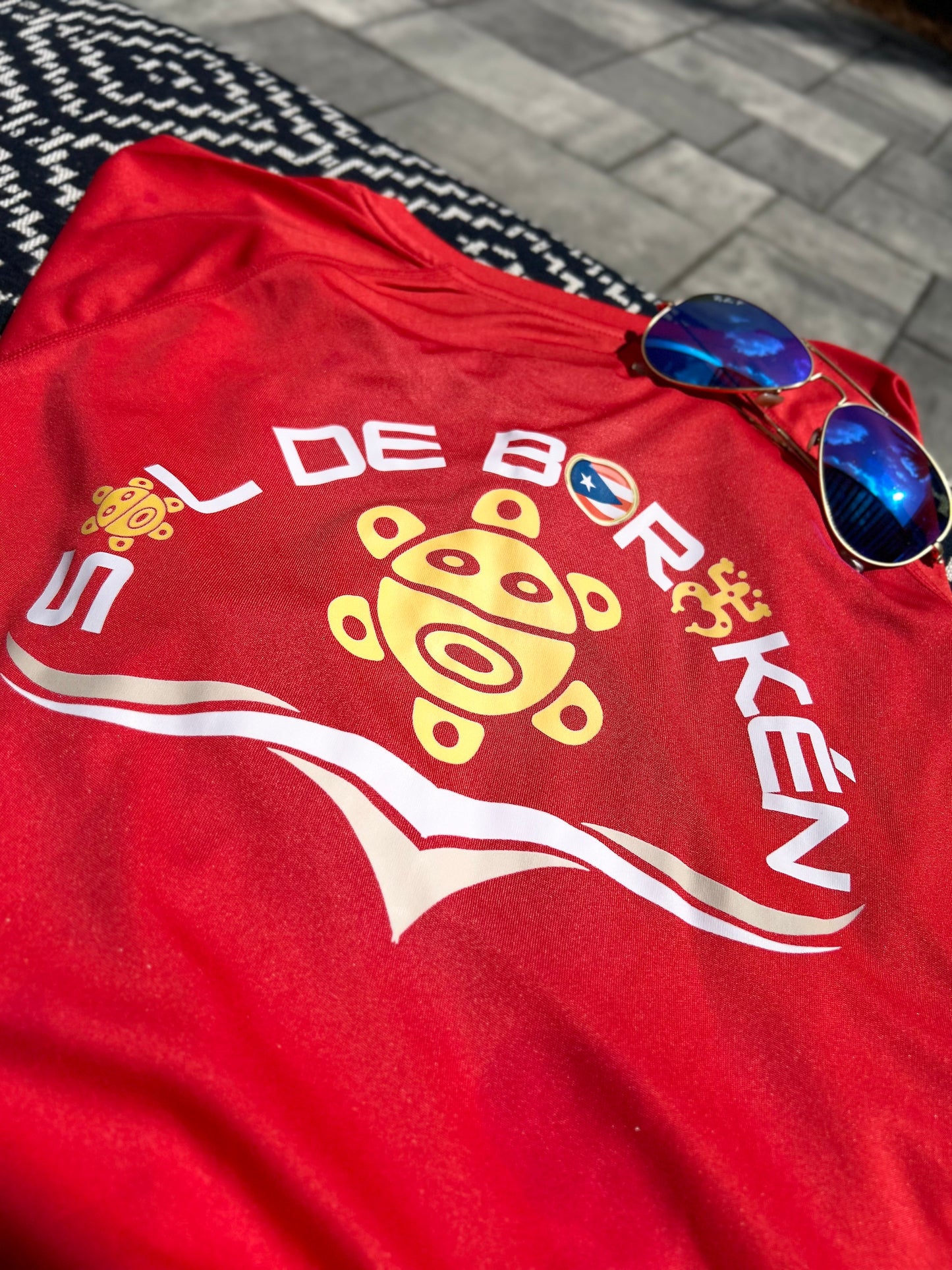 Adult wearing Sol de Borikén unisex UPF 50+ sun shirt, breathable loose-fit for sun protection