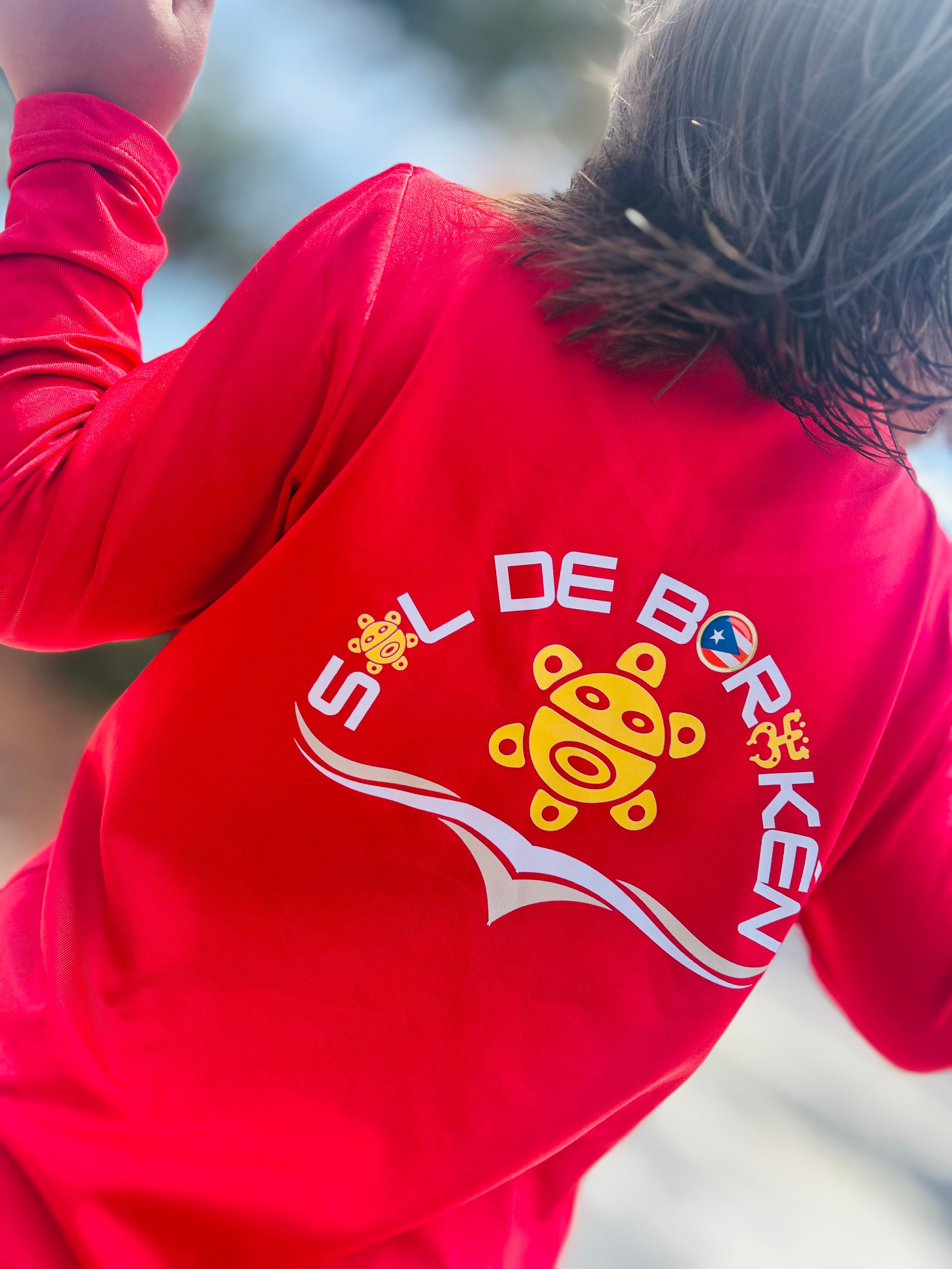 Child wearing Sol de Borikén loose-fit UPF 50+ sun shirt, sensory-friendly design for outdoor protection