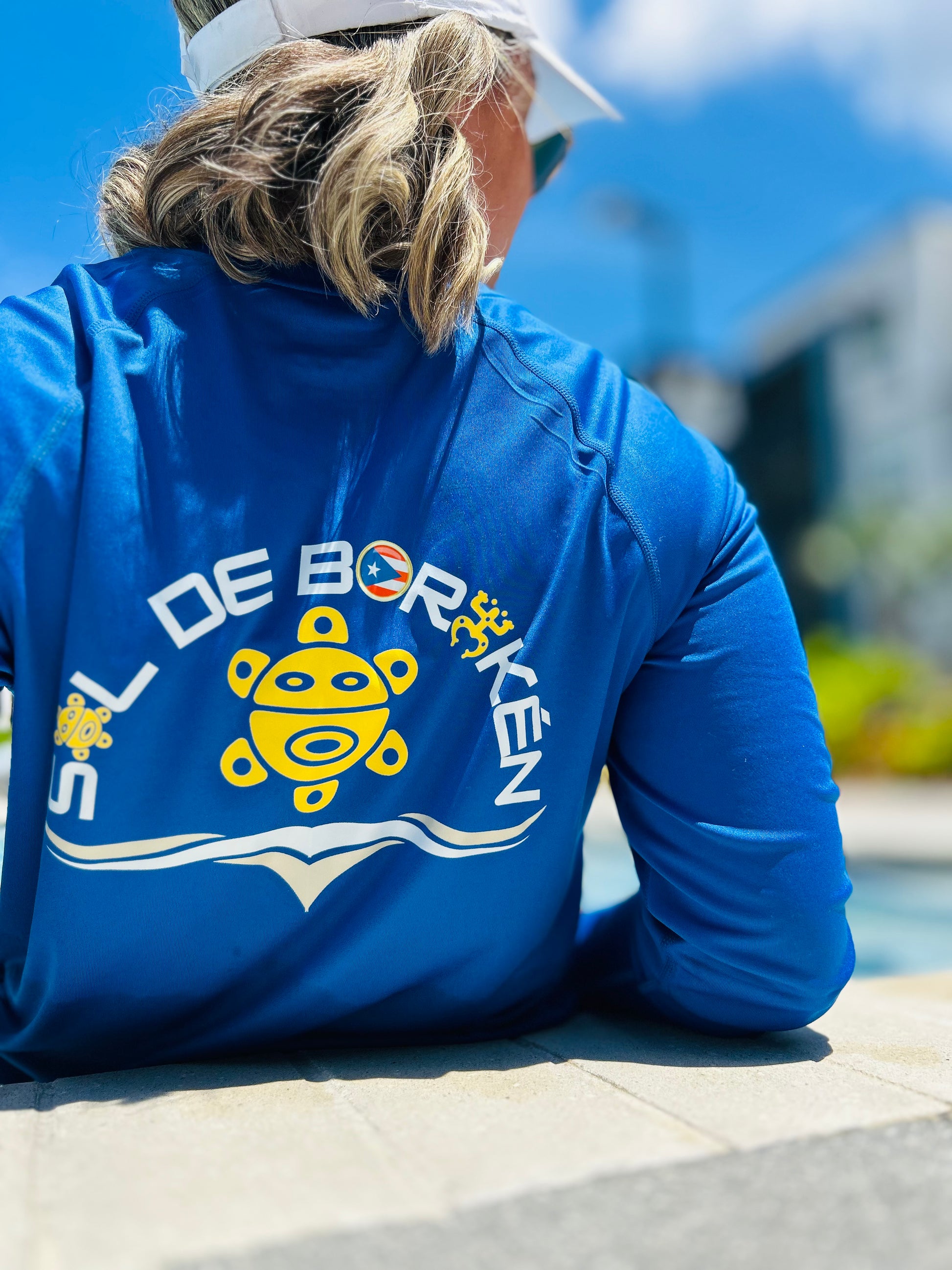 Adult wearing Sol de Borikén unisex UPF 50+ sun shirt, breathable loose-fit for sun protection